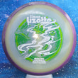 Load image into Gallery viewer, Top-down view of an Axiom Aspect fairway driver disc golf disc in Eclipse Glow plastic with a black and purple overmold rim and a white, green, and lime foil Simon Lizotte Halloween Tour Series stamp.
