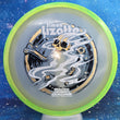 Load image into Gallery viewer, Top-down view of an Axiom Aspect fairway driver disc golf disc in Eclipse Glow plastic with a lime green and yellow overmold rim and a black, white, and gold holographic foil Simon Lizotte Halloween Tour Series stamp.
