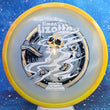 Load image into Gallery viewer, Top-down view of an Axiom Aspect fairway driver disc golf disc in Eclipse Glow plastic with a yellow and red overmold rim and a black, white, and gold holographic foil Simon Lizotte Halloween Tour Series stamp.
