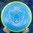 Load image into Gallery viewer, Top-down view of a blue Axiom Defy distance driver disc golf disc in Fission plastic with a lime and yellow GYRO overmold rim and silver foil stock Defy stamp.
