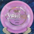 Load image into Gallery viewer, Top-down view of a pink and purple sparkle DGA Catrina Allen Typhoon distance driver disc golf disc in Atmos Sparkle plastic featuring a silver holographic foil Typhoon stamp.
