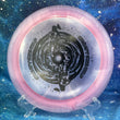 Load image into Gallery viewer, Top-down view of a pink sparkle DGA Torrent distance driver disc golf disc in SP Line plastic featuring a black foil Black Hole special edition stamp.
