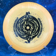Load image into Gallery viewer, Top-down view of a light orange DGA Undertow hybrid control driver disc golf disc in ProLine plastic featuring a black foil Black Hole special edition stamp.

