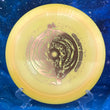 Load image into Gallery viewer, Top-down view of a light orange DGA Undertow hybrid control driver disc golf disc in ProLine plastic featuring a gold foil Black Hole special edition stamp.
