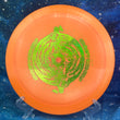 Load image into Gallery viewer, Top-down view of an orange DGA Undertow hybrid control driver disc golf disc in ProLine plastic featuring a green shimmer foil Black Hole special edition stamp.
