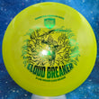Load image into Gallery viewer, A bright yellow-green Discmetrics Cannon Dives Signature Series Cloud Breaker disc golf disc, featuring a black graphic of a diving bird breaking clouds, displayed on a blue starry background.
