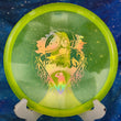 Load image into Gallery viewer, Top-down view of a neon yellow metal flake Discmania MD3 midrange disc golf disc in Metal Flake C-Line plastic featuring a gold holographic foil Unearthed special edition stamp.
