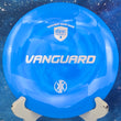 Load image into Gallery viewer, Top-down view of a blue swirled Discmania Vanguard fairway driver disc golf disc in Swirl S-Line plastic featuring a silver holographic foil Kyle Klein Creator Series stamp.
