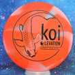 Load image into Gallery viewer, Top-down view of a brand new carnelian orange and white GLO-G Elevation Discs Koi putt and approach disc golf disc featuring a black matte koi fish foil stamp.
