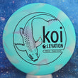 Load image into Gallery viewer, Top-down view of a brand new icey light blue GLO-G Elevation Discs Koi putt and approach disc golf disc featuring a black matte koi fish foil stamp.
