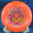 Load image into Gallery viewer, 173g Orange I-Blend Infinite Discs Centurion featuring a 3-foil Special Edition Alien Head stamp in lime, pink, and blue.
