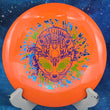 Load image into Gallery viewer, Orange I-Blend Infinite Discs Centurion fairway driver, 173g, with a Special Edition 3-foil Alien Head stamp in lime, purple, and blue.
