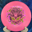 Load image into Gallery viewer, Top-down view of a pink Infinite Discs Cohort putt and approach disc golf disc in I-Blend plastic with a black, lime green, and purple three-foil Neon Alien Head stamp.
