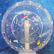 Load image into Gallery viewer, Top-down view of an Innova Fox Ohn Scoggins Commemorative Party Time midrange disc golf disc in purple and white Proto Glow Champion Halo plastic with a money holographic foil stamp scaled at 179g.
