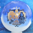 Load image into Gallery viewer, Top-down view of an Innova Teebird Rainers Balodis Commemorative fairway driver in blue and white Duo Star plastic with black and gold holo foil stamp scaled at 174g.
