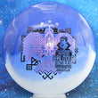 Load image into Gallery viewer, Top-down view of an Innova Teebird Rainers Balodis Commemorative fairway driver in blue and white Duo Star plastic with black and lavender holo foil stamp scaled at 175g.
