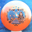 Load image into Gallery viewer, Top-down view of an Innova Teebird Rainers Balodis Commemorative fairway driver in white and orange Duo Star plastic with black and blue holo foil stamp scaled at 175g.
