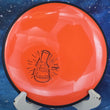 Load image into Gallery viewer, Orange frisbee with a black design on a blue background
