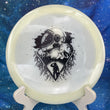 Load image into Gallery viewer, Top-down view of a glow Mint Discs Phoenix fairway driver disc golf disc in Nocturnal Glow plastic featuring a black foil Unearthed special edition stamp.
