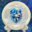 Load image into Gallery viewer, Top-down view of a glow Mint Discs Phoenix fairway driver disc golf disc in Nocturnal Glow plastic featuring a blue foil Unearthed special edition stamp.
