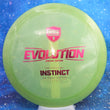 Load image into Gallery viewer, Top-down view of a pre-owned green glimmer Discmania Instinct fairway driver disc golf disc in Special Edition Forge plastic scaled at 172g in 9 out of 10 uninked condition.
