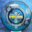 Load image into Gallery viewer, Top-down view of a pre-owned blue and black dyed Dynamic Discs Felon Eric Oakley 2020 bullet holes edition fairway driver disc golf disc in Lucid X plastic scaled at 173g in brand new 10 out of 10 uninked condition.
