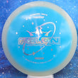 Load image into Gallery viewer, Top-down view of a pre-owned glow and blue Dynamic Discs Felon featuring a money stamp in Moonshine Orbit plastic scaled at 176g in brand new 10 out of 10 uninked condition.
