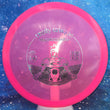Load image into Gallery viewer, Top-down view of a pre-owned pink 2016 Limited Edition Truly Unique Trilogy Man Westside Discs Warship midrange disc golf disc in VIP plastic scaled at 172g in brand new 10 out of 10 uninked condition.
