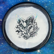 Load image into Gallery viewer, Top-down view of a pre-owned black and white Chill At The Hill Fox stamp Westside Harp approach disc golf disc in Gold Line Orbit plastic scaled at 174g in brand new 10 out of 10 uninked condition.
