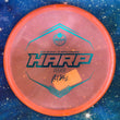 Load image into Gallery viewer, Top-down view of a pre-owned neon orange Ricky Wysocki tour series Westside Harp approach disc golf disc in VIP Glimmer plastic scaled at 174g in brand new 10 out of 10 uninked condition.
