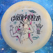 Load image into Gallery viewer, Top-down view of a pre-owned white Axiom Discs Vanish Gyropalooza run distance driver disc golf disc in Eclipse Glow plastic scaled at 176g in 8 out of 10 condition with ink on bottom.
