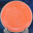 Load image into Gallery viewer, Top-down view of a pre-owned orange swirl Axiom Envy putt and approach disc golf disc in Neutron Soft plastic with a white rim scaled at 175g in 7.5 out of 10 inked condition.
