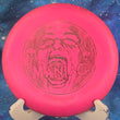 Load image into Gallery viewer, Pre-owned bright pink Discmania P1 Soft P-Line plastic putter, 169g, "The Maniac" specialty edition featuring a black "penned" Innova-made stamp with a screaming face graphic in 7.5/10 inked condition.
