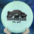 Load image into Gallery viewer, Pre-owned light blue Discraft Buzzz Glow Z plastic midrange, featuring a large black "BUSHWACKERS disc golf" specialty stamp with "2000-2019" anniversary graphics and local course names in new 10/10 condition.
