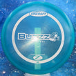 Load image into Gallery viewer, Top-down view of a pre-owned translucent blue Discraft Buzzz pre-flight numbers edition midrange disc golf disc in Elite Z plastic scaled at 171g in 8 out of 10 uninked condition.

