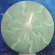 Load image into Gallery viewer, Top-down view of a pre-owned green and lime swirly Discraft Comet Michael Johansen tour series midrange disc golf disc in ESP Swirl plastic scaled at 178g in 7.5 out of 10 inked condition.
