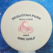 Load image into Gallery viewer, Top-down view of a pre-owned white Innova Roc 2004 patent number PFN midrange disc golf disc in KC Pro plastic with original sticker scaled at 175g in 9 out of 10 uninked condition.
