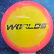 Load image into Gallery viewer, Top-down view of a pre-owned pink and yellow Innova Roc 2026 Worlds edition midrange disc golf disc in Halo Star plastic scaled at 180g in brand new 10 out of 10 uninked condition.
