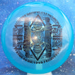 Load image into Gallery viewer, Top-down view of a blue pre-owned Latitude 64 Sinus putter disc golf disc in Opto plastic featuring a Handeye bottom stamp rated 9.5/10 condition.
