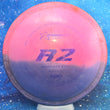 Load image into Gallery viewer, Top-down view of a pre-owned pink and blue half-dyed Prodigy A2 overstable approach disc golf disc in 500 plastic scaled at 171g in 8 out of 10 condition with ink on back.
