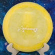 Load image into Gallery viewer, Top-down view of a pre-owned yellow Prodigy D4 X-Out distance driver disc golf disc in chalky 400G plastic scaled at 173g in 9.5 out of 10 uninked condition.
