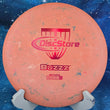 Load image into Gallery viewer, Pre-owned orange Discraft Buzzz Recycled plastic midrange, lightweight 119g, featuring a red and blue "Disc Store" specialty stamp in 9/10 inked condition.
