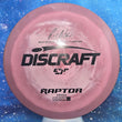 Load image into Gallery viewer, Top-down view of a pre-owned maroon and pink Ricky Wysocki Discraft Raptor fairway driver disc golf disc in ESP Swirl plastic scaled at 176g in 7.5 out of 10 inked flat condition.
