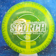 Load image into Gallery viewer, Top-down view of a pre-owned neon yellow with glow rim Discraft Scorch distance driver disc golf disc in Ledgestone Mega Glow plastic scaled at 174g in 9 out of 10 uninked puddletop condition.
