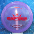 Load image into Gallery viewer, Top-down view of a pre-owned purple translucent Dynamic Discs Captain distance driver disc golf disc in Lucid plastic scaled at 176g in 8 out of 10 inked condition.
