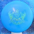 Load image into Gallery viewer, Top-down view of a pre-owned blue Trilogy Man Truly Unique Dynamic Discs Deputy putter disc golf disc in Classic Blend plastic scaled at 175g in 10 out of 10 uninked condition.
