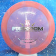 Load image into Gallery viewer, Top-down view of a pre-owned red and purple burst Dynamic Discs Freedom distance driver disc golf disc in Lucid plastic scaled at 172g in 10 out of 10 uninked condition.
