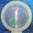 Load image into Gallery viewer, Top-down view of a pre-owned white glow KC Mini Series stamped Dynamic Discs Freedom distance driver disc golf disc in Moonshine Glow plastic scaled at 170g in 10 out of 10 uninked condition.
