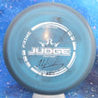 Load image into Gallery viewer, Top-down view of a pre-owned blue and grey swirl signed Dynamic Discs Judge putter disc golf disc in Prime plastic scaled at 176g in 10 out of 10 uninked condition.
