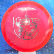 Load image into Gallery viewer, Top-down view of a pre-owned red 2022 Cross Winds Open tournament stamped Dynamic Discs Justice midrange disc golf disc in Classic Blend plastic in 9.5 out of 10 uninked condition.
